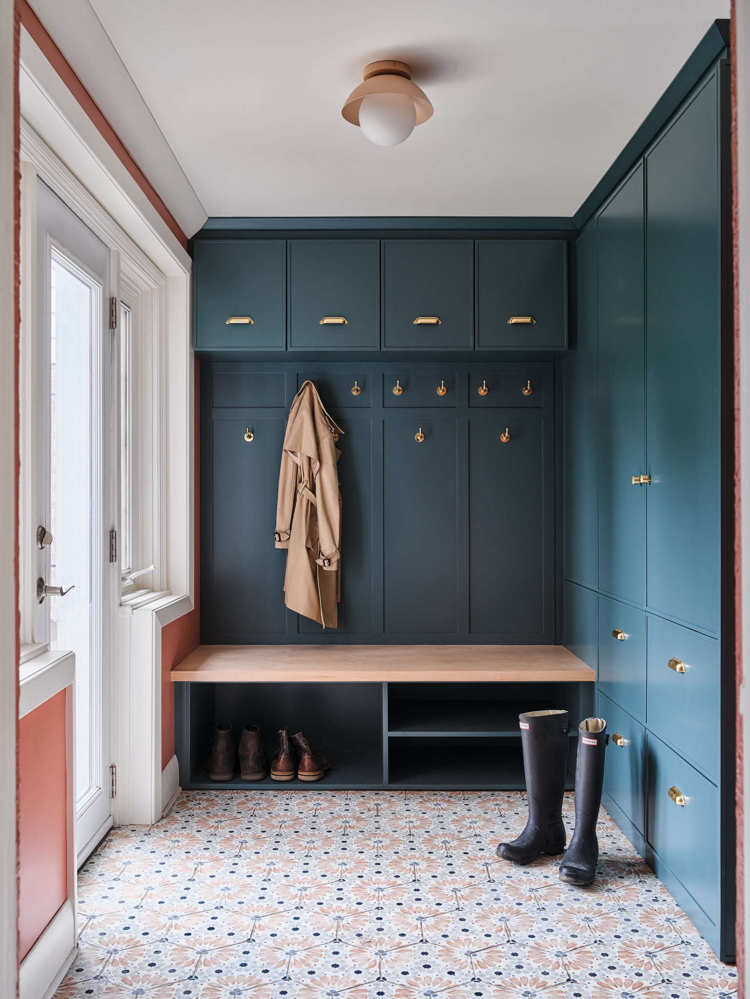 Custom home entrance featuring cabinetry and walls painted with Farro & Ball wall paint products.