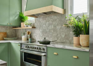 green kitchen with custom built green cabinetry and details